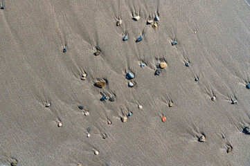 Small stones on the sand of a beach