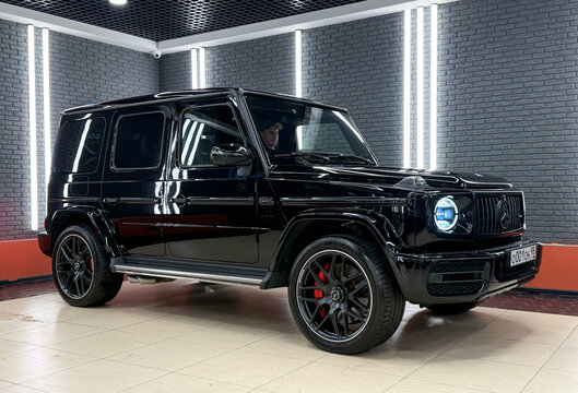 Black Mercedes Benz G63 AMG. Mercedes Benz G SUV Brabus tuning car. Black Mercedes-Benz W500 G-class in the showroom side view. Gel&auml;ndewagen. Brabus G Wagon. 