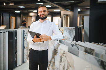 A male seller of ceramic tiles in a hardware store