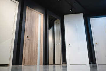 The samples of various wooden doors in the exhibition area of a store