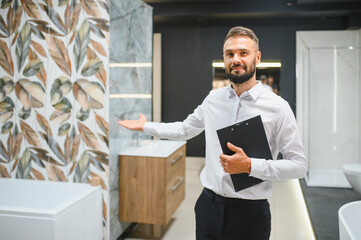 Portrait of seller in bathroom store. Happy man works in bath store. Sales occupation