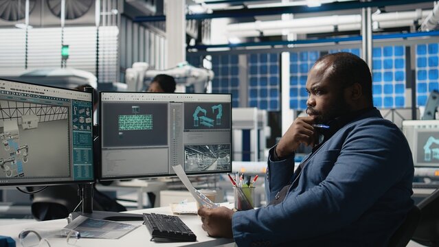 Industrial operations expert checking performance data in a solar panel factory, showcasing dedication to workplace efficiency and working on green energy manufacturing and engineering. Camera A.