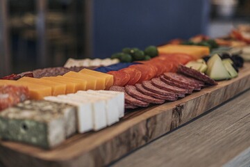 Flat lay of assorted Middle Eastern food and wine on a decorative blue wooden table

