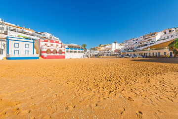 The picturesque seaside, whitewashed fishing village of Carvoeiro Portugal, along the Algarve coastline region of southern Portugal.