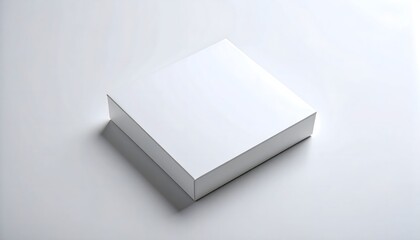 A clean white square box sits diagonally on a bright white surface with its shadow, presenting a minimalist and modern presentation of packaging design.