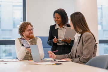 A diverse and dynamic team collaborates effectively during a highly productive meeting in a modern...