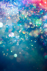Rainbow of sparkling glitter creating mystical and vibrant spectrum of colors. Dreamy or magical shimmering particles glowing in a bokeh of lights. Ethereal aura with vivid colors abstract background.