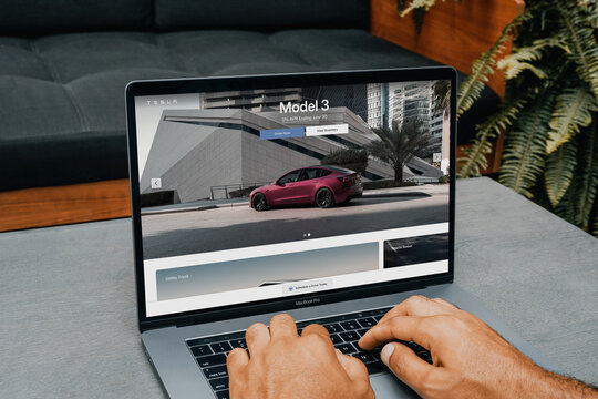 Customer configuring a tesla model 3 on a macbook pro