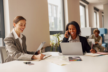 Two women engaged in a meaningful professional discussion in a modern contemporary workspace...