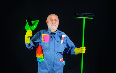 Cleaning day. Bearded man in uniform with broom, dustpan and brush for carpet. Cleaning agency....