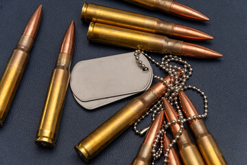 Close-up of ammunition and two metal army badges. The composition conveys the themes of the armed forces and veterans.