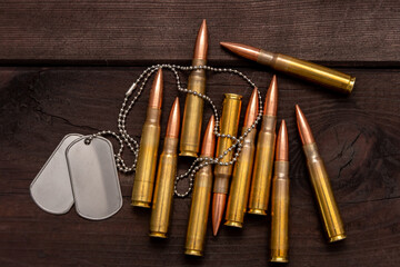 Close-up of army badges and live ammunition against a dark background, symbolising the concept of mercenary and military service.