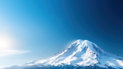 A breathtaking view of a majestic snow-capped mountain set against a clear blue sky, symbolizing strength, tranquility, and the beauty of nature's untouched landscapes.