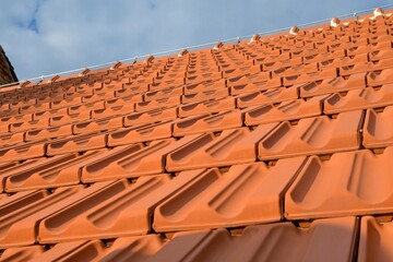 Newly covered roof. New roofing with terracotta tiles. Concept of construction and building works