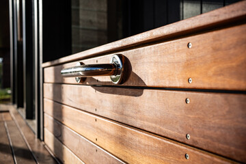 chrome handle on modern wooden box