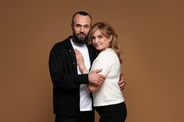 Portrait of lovely couple on brown background
