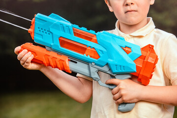 Perfect summer activity, game, fun, and playful childhood concept. Great image for themes like outdoor fun, summer games, kids’ activities. Detail of   water gun game.