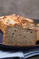 Cut banana bread with nuts on table, closeup