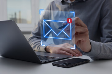 Email marketing, new message notification. Man using virtual screen above laptop at table, closeup