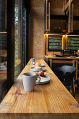 A breakfast bar with stools displaying plates of toast, fruit, and coffee. The warm sunlight enhances the cozy, relaxed feel, perfect for capturing morning meal moments.

