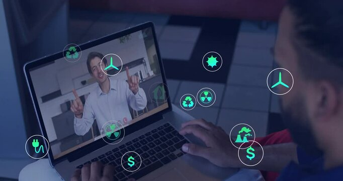 Man tapping trackpad starting call, colleague showing energy data with icons popping up on laptop