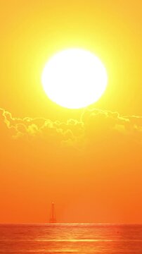 Time lapse of the sun rising through the clouds at dawn in Key West Florida. Vertical Video.