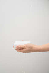 Hand Holding Wet Sponge Under Running Water – Cleaning Concept