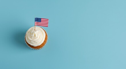 Patriotic cupcake adorned with a miniature American flag, on a light blue background.