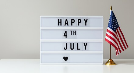 A white lightbox displaying "Happy 4th July" with an American flag, celebrating Independence Day.