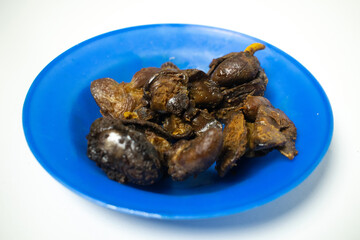A delicious chicken liver dish, cooked until tender and seasoned, served on a blue plate.