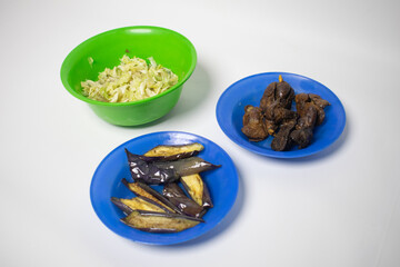 Traditional side dishes served on the plate are eggplant, cabbage and chicken liver.