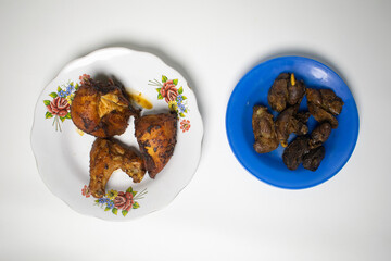 Fried chicken liver and fried chicken served on a plate.