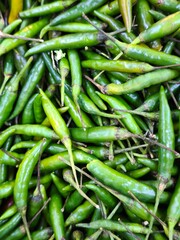 A substantial heap of bright red hot peppers, emphasizing their fiery appearance and fresh quality