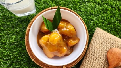 Candil porridge is made from sticky rice flour, brown sugar and coconut milk, shaped like balls or...