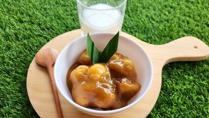 Candil porridge is made from sticky rice flour, brown sugar and coconut milk, shaped like balls or...
