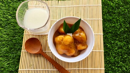 Candil porridge is made from sticky rice flour, brown sugar and coconut milk, shaped like balls or...