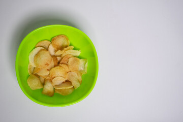 Delicious fried chips in a bright green bowl, perfect for snacking.