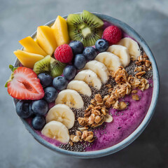 A vibrant smoothie bowl topped with banana slices, granola, chia seeds, blueberries, kiwi, raspberry, mango, and a strawberry slice.