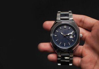 hand holding elegant silver watch. steel watch