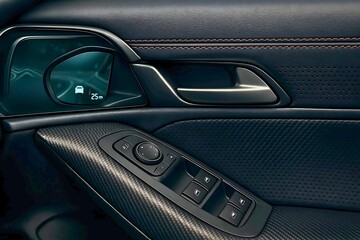 Close-up of modern car door panel with digital display and textured black leather and stitching