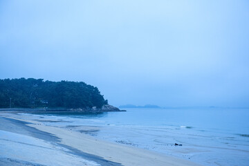 Amazing seashore sunrising,endless horising and  sea waves beats on a sand shore with foam.