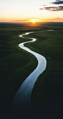 Winding river meanders through verdant plains at sunset