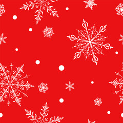 Christmas seamless pattern with big and small intricate snowflakes in various designs and small circles, white on red background.