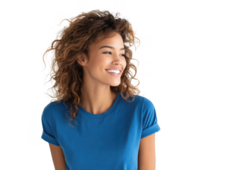A cheerful young woman with curly hair wearing a blue t-shirt smiles brightly while looking to the side against a plain white background. radiating positivity and confidence