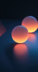 Two glowing orbs on dark surface