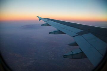 Obraz premium Beautiful Sunset over Los Angeles, Californita, United States on a flight with the airplane wing.