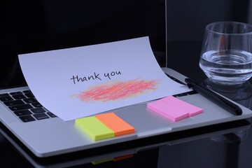 Thank you note on laptop with sticky notes