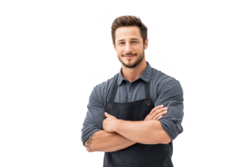 A confident young male chef in a dark apron stands with arms crossed. smiling against a plain white background. suggesting professionalism and readiness for culinary tasks