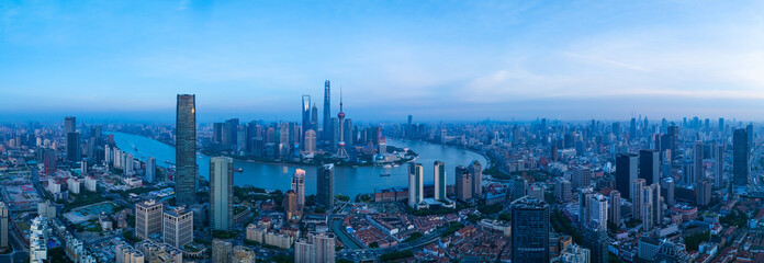 Panoramic Aerial view of Shanghai skyline and winding river on sunny day.
