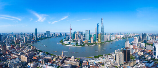 Panoramic Aerial view of Shanghai skyline and winding river on sunny day.
